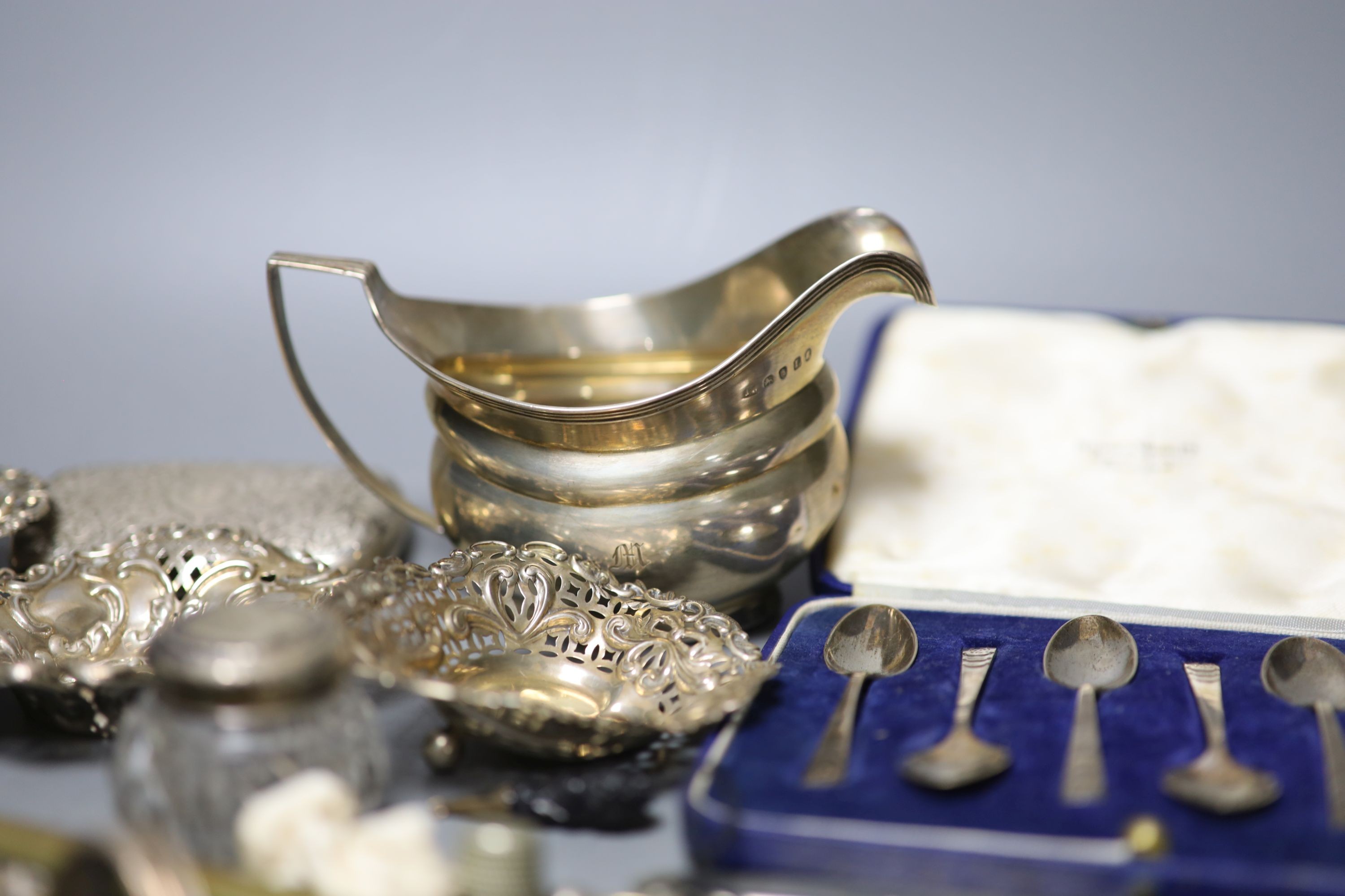 Mixed small silver and other collectable including a cased set of silver silver coffee spoons, a George III silver cream jug, bonbon dishes, cigarette cases, vesta case, flatware, scent bottles, a cold painted bronze bir